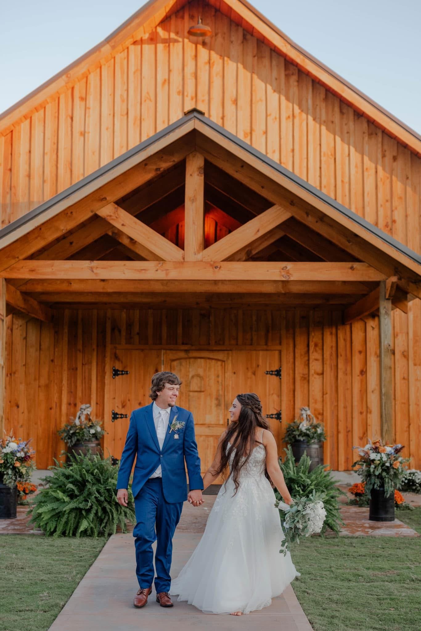 Bride and groom walking the outdoor aisle at the Grant Gables barn entrance